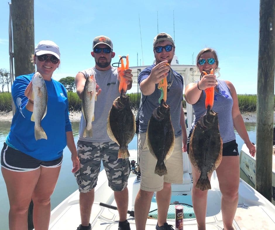 Group on a fishing charter holding up the fish they caught
