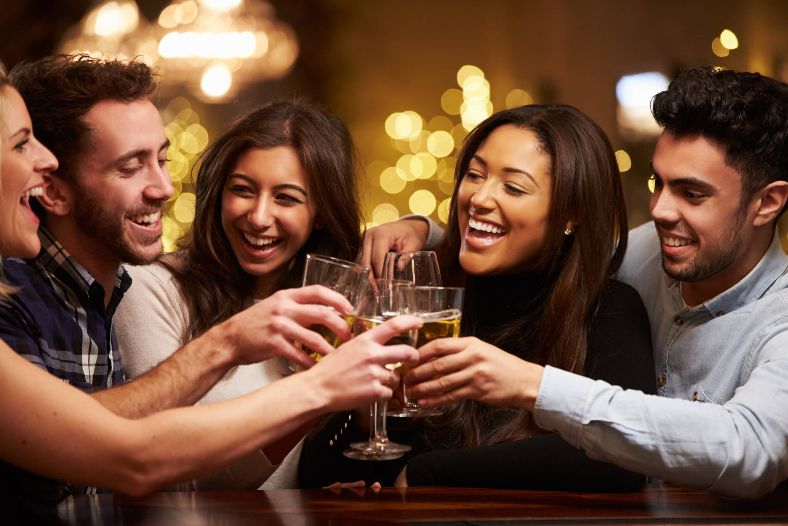 Group of adults drinking beer at happy hour