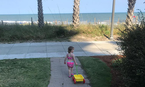 Little Girl pulling wagon