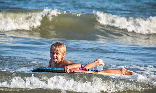 Little boy body surfing
