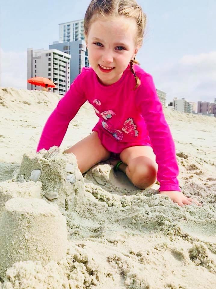 Little girl building sand castle