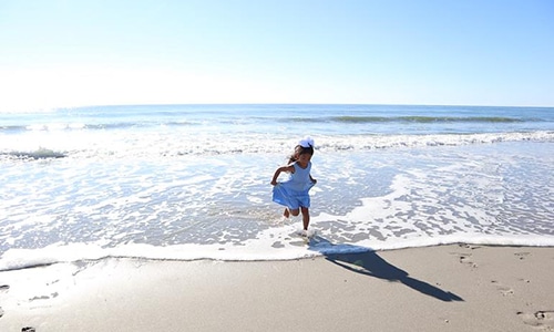 Little Girl Running on Beach