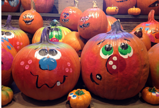 Pumpkin painted with a face on it