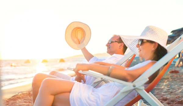Couple relaxing on the beach at a Bay View Resort winter rental.